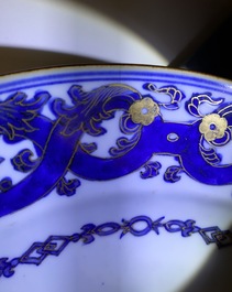 A pair of Chinese gilt-decorated blue and white chargers, Qianlong